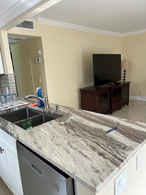 740 Monaco P, Unit P Delray Beach, FL 33446 - Photo 4 of 14 a living room with kitchen island furniture and a flat screen tv