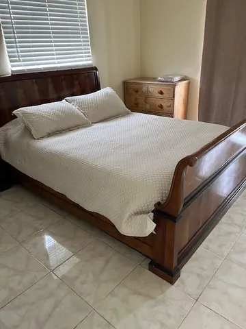 a bedroom with a bed and window