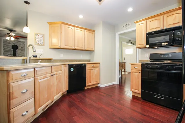 a kitchen with a sink stove and microwave