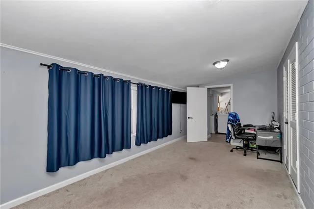 a view of a room with furniture and a window