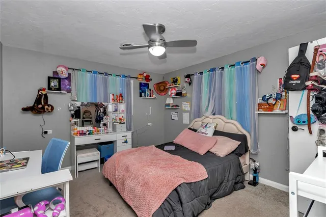 a bedroom that has a bed and a desk in it