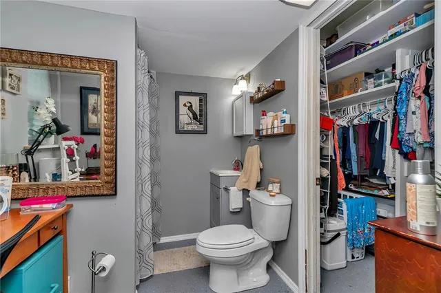 a bathroom with a toilet and a shower curtain