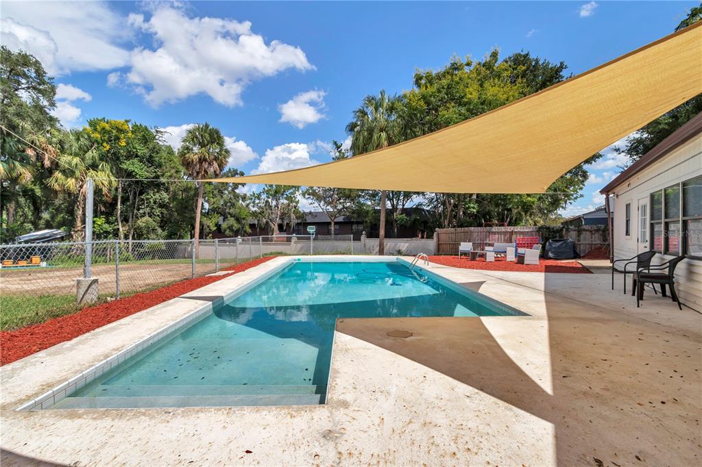 2433 Northeast 2nd Street Ocala, FL 34470 - Photo 38 of 45 a view of a swimming pool with an outdoor seating