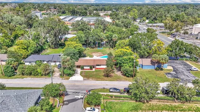 an aerial view of residential houses with outdoor space and street view