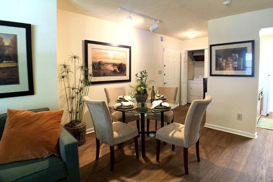 3450 K Jones Mill Road, Unit 218 Norcross, GA 30092 - Photo 3 of 29 a dining room with furniture and wooden floor