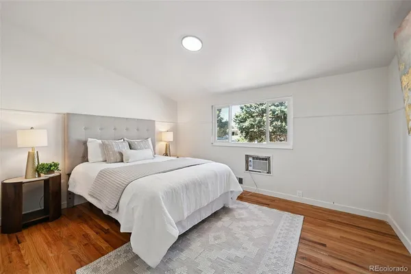 a bedroom with a large bed and a window