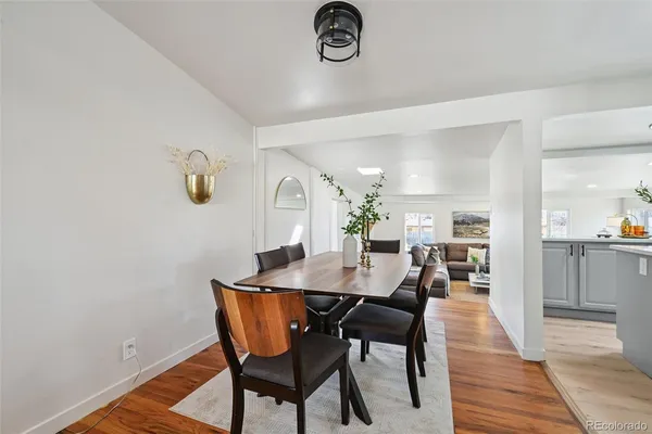 a view of a dining room with furniture and wooden floor