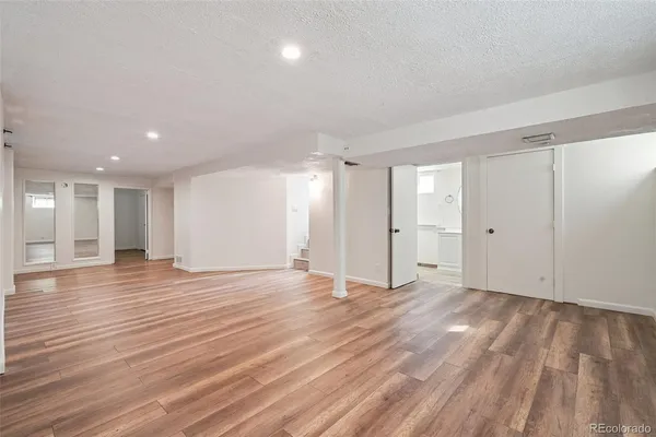 a view of an empty room with wooden floor
