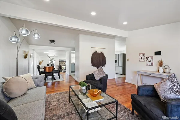 a living room with furniture and wooden floor