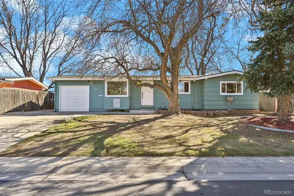 a view of a house with snow on the road