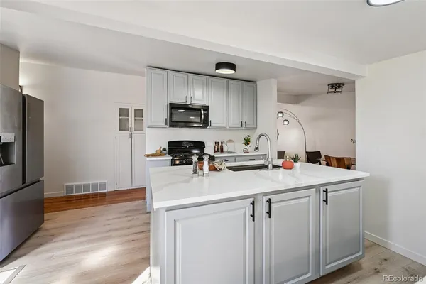 a kitchen with appliances cabinets and a sink