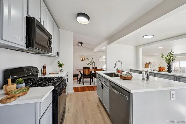 a kitchen with a sink stove and cabinets