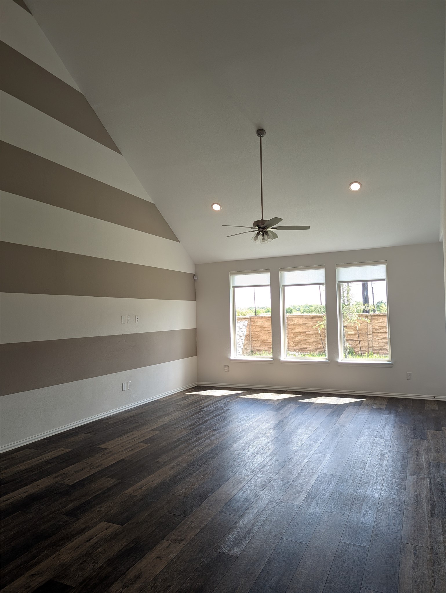 10503 Dolce Lane Rosharon, TX 77583 - Photo 9 of 41 a view of an empty room with a window and wooden floor