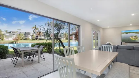 a dining room with furniture and a floor to ceiling window