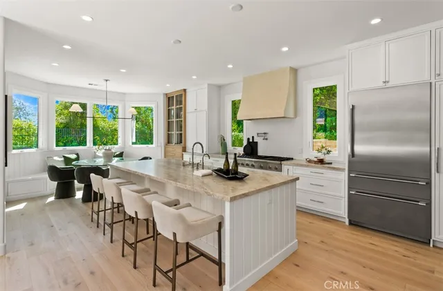a kitchen with stainless steel appliances granite countertop counter space a sink and a refrigerator