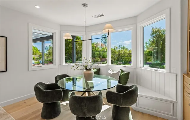 a dining room with furniture and a large window