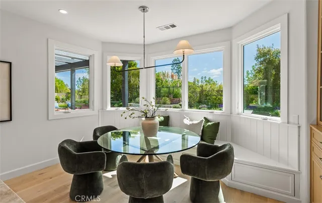 a dining room with furniture and a large window