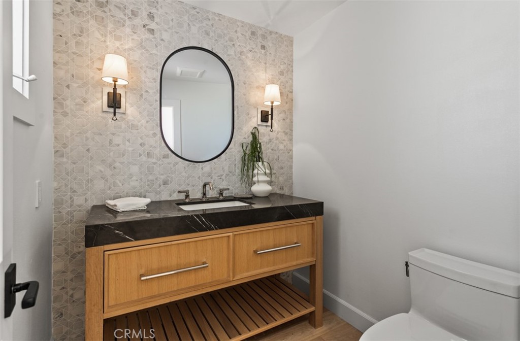 38 Royal St George Road Newport Beach, CA 92660 - Photo 27 of 44 a bathroom with a granite countertop toilet a sink and a mirror