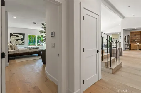 a view of a hallway and a livingroom with furniture