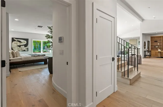 a view of a hallway and a livingroom with furniture