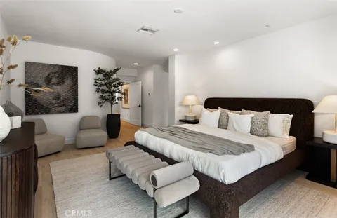 a spacious bedroom with a bed and couch