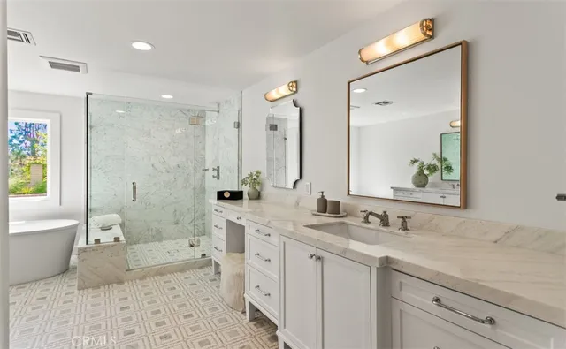 a spacious bathroom with a double vanity sink mirror double and bathtub