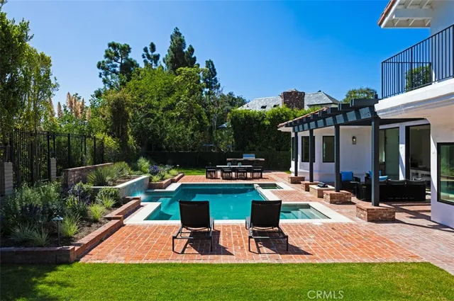 a view of backyard of house with seating space