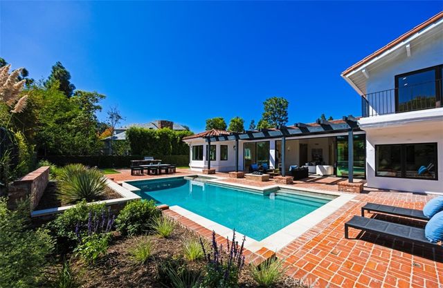 a view of a house with swimming pool and sitting area