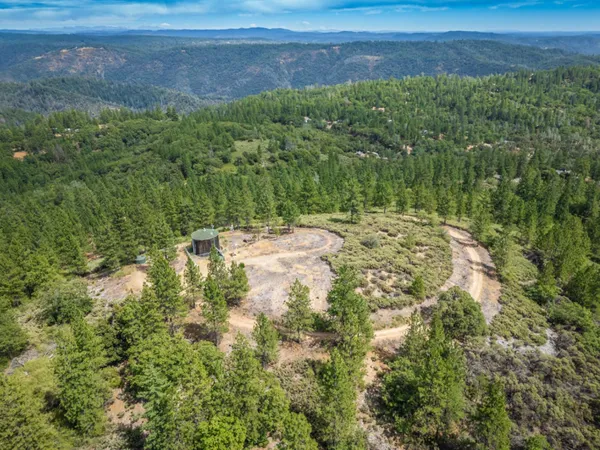 an aerial view of residential houses with city view and mountain view in back