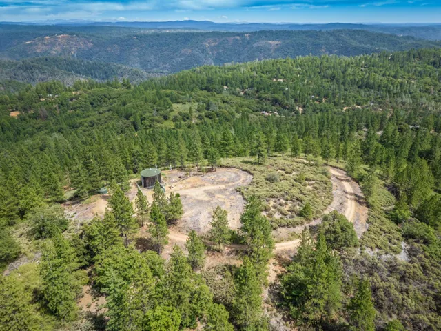an aerial view of residential houses with city view and mountain view in back