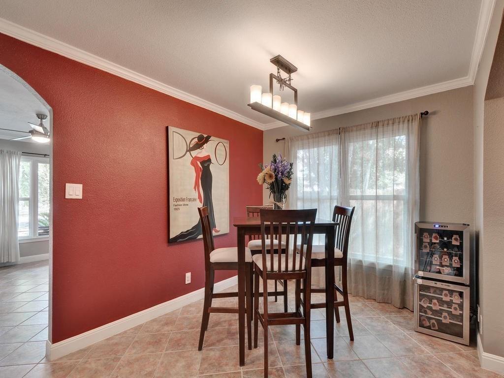 610 West N Loop Boulevard Austin, TX 78751 - Photo 12 of 29 This room features tiled flooring, a red accent wall, and a window with sheer curtains