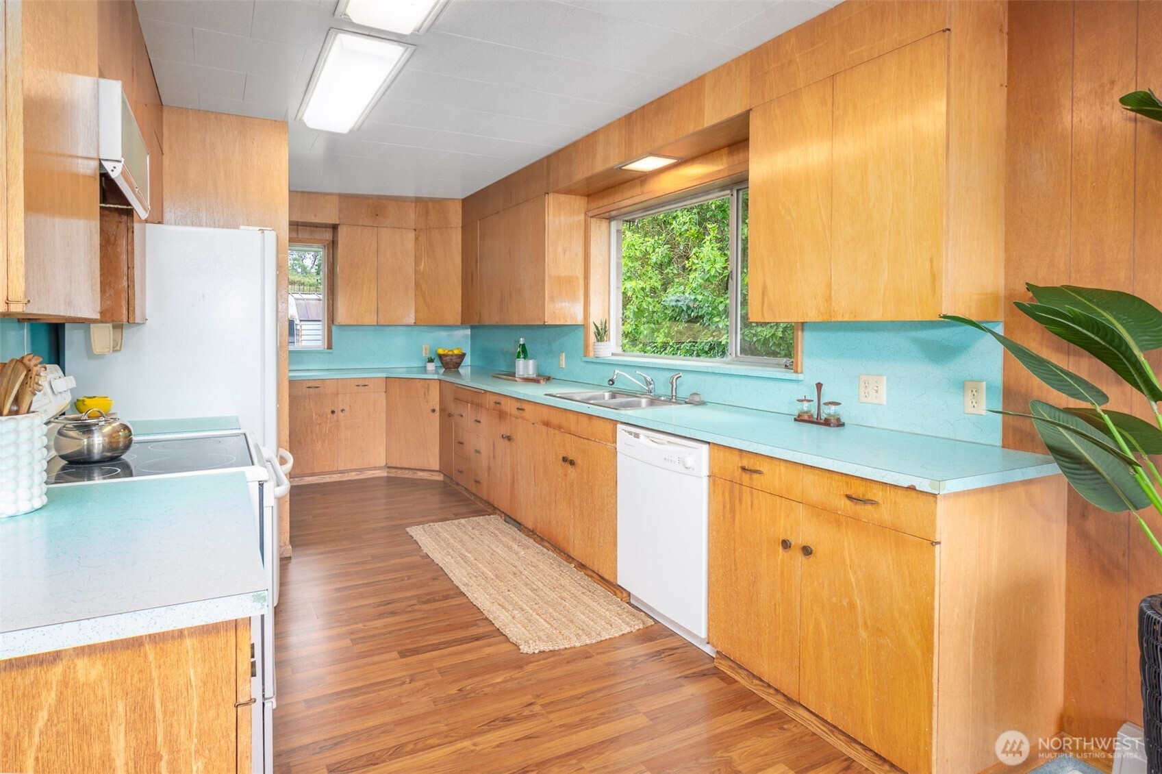 22617 Kingsbury Road Southwest Vashon, WA 98070 - Photo 14 of 29 a kitchen with a sink a counter top space and cabinets