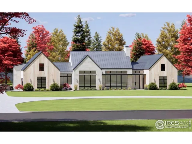 a front view of a house with a big yard and potted plants