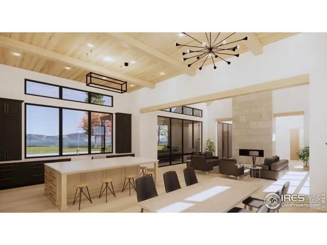 a living room with stainless steel appliances kitchen island granite countertop furniture and a large window
