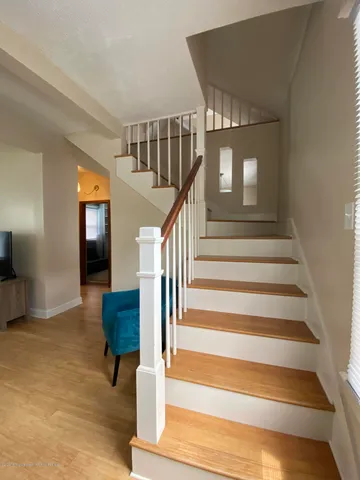 a view of entryway and hall with wooden floor