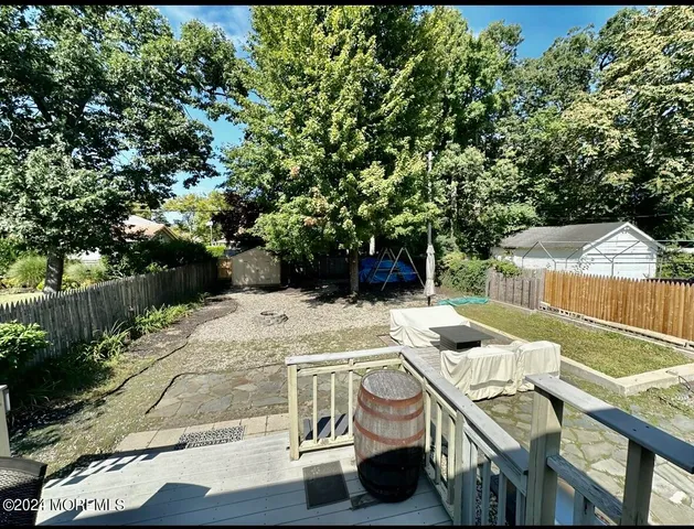 a patio with glass top table and chairs
