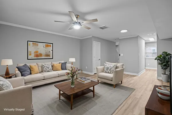a living room with furniture and a potted plant