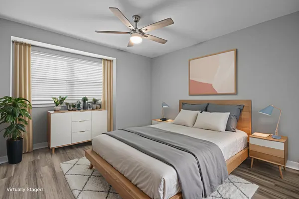 a bedroom with a large bed and a large window