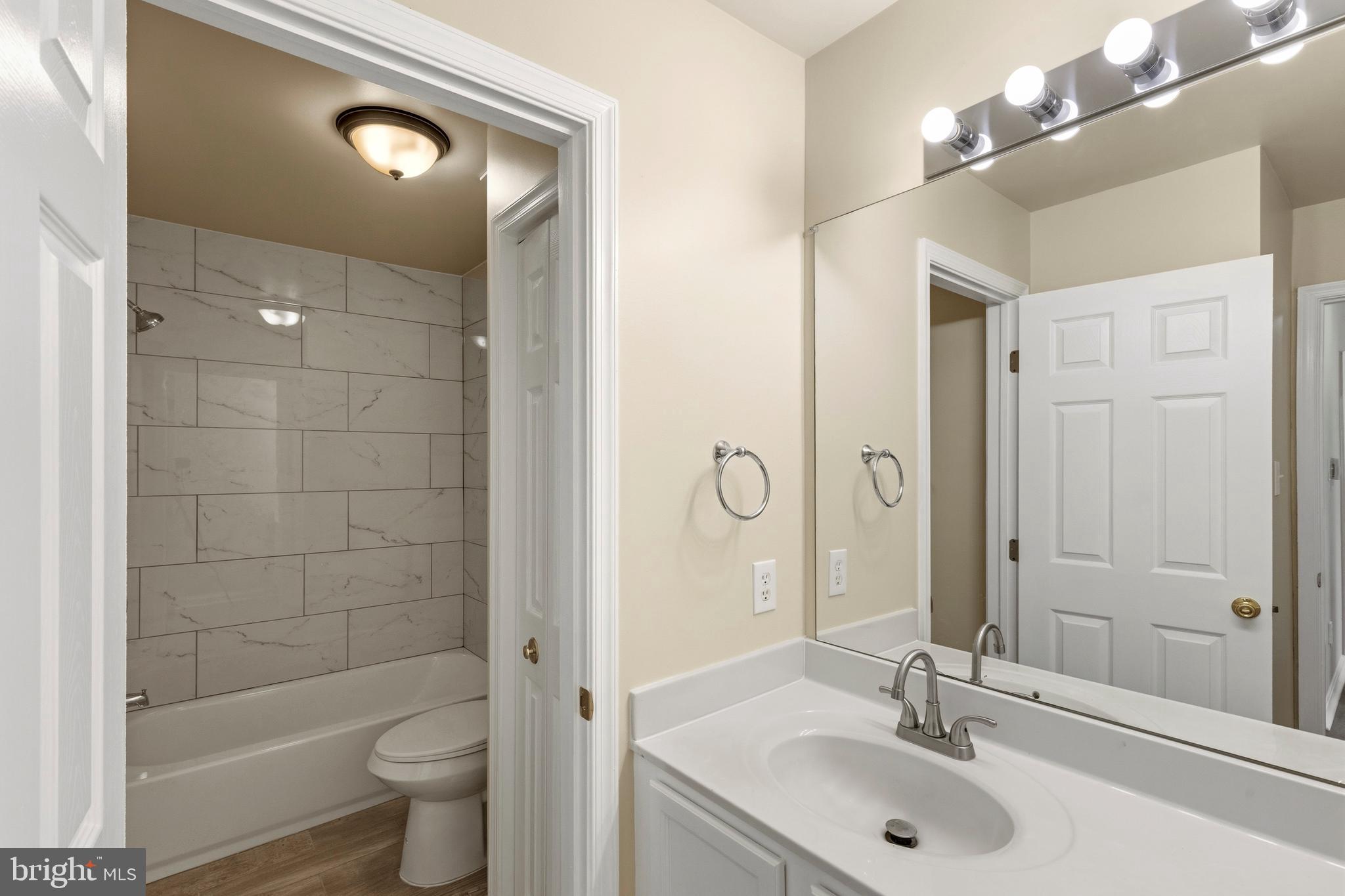 4704 Denview Way Baltimore, MD 21206 - Photo 21 of 42 a bathroom with a sink a toilet and shower