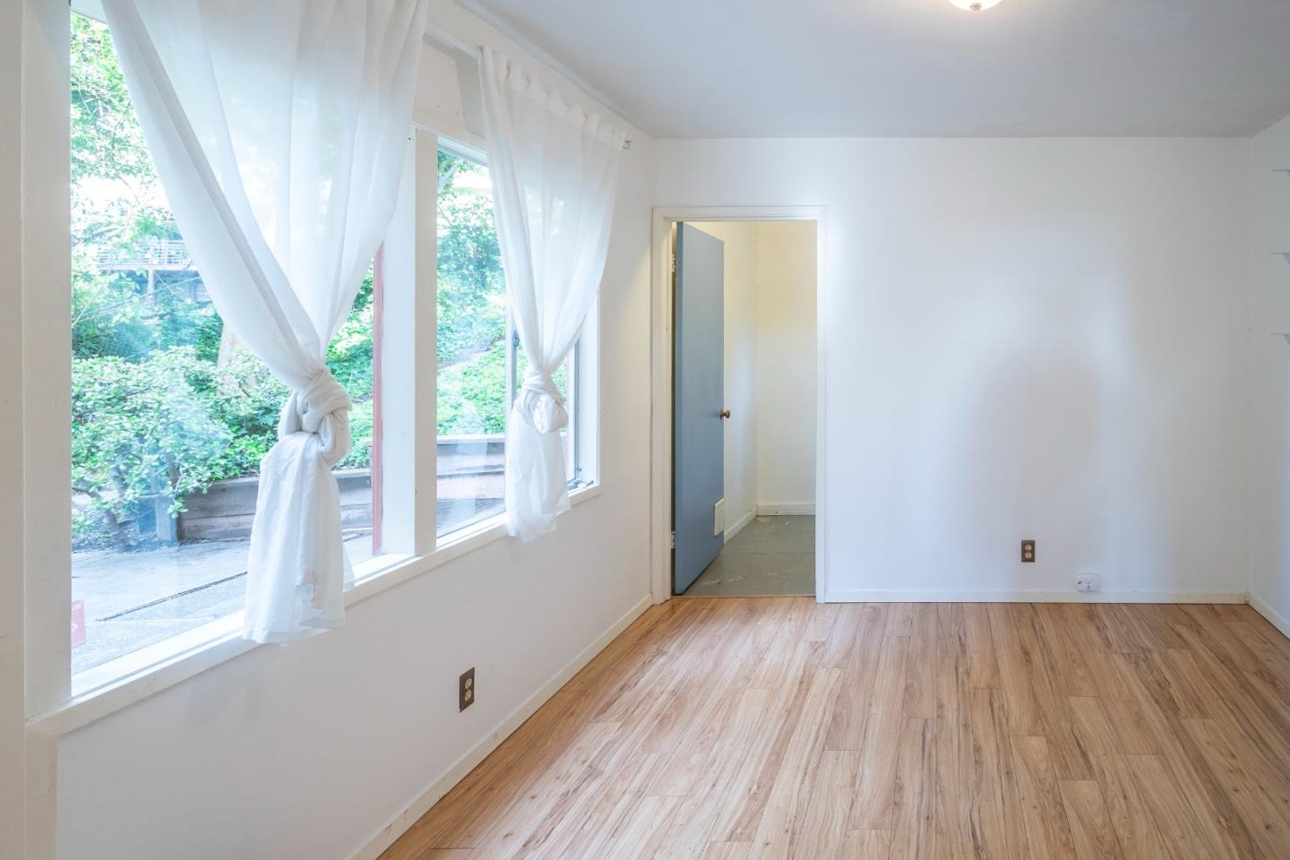 230 Fairlawn Drive Berkeley, CA 94708 - Photo 5 of 33 a view of an empty room with wooden floor and a window