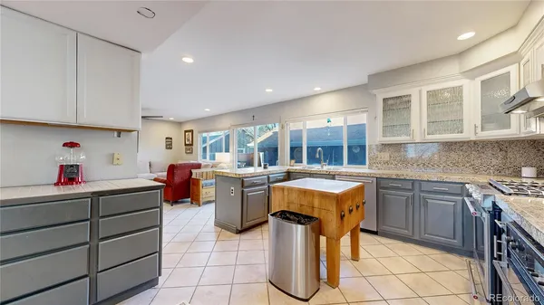 a kitchen that has a lot of cabinets in it and appliances