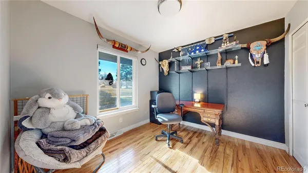 a work room with furniture and wooden floor