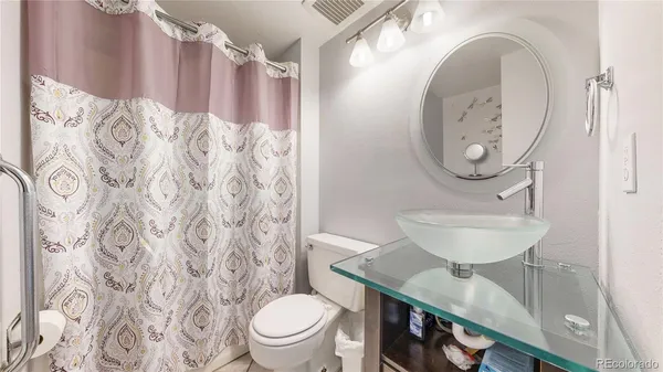 a bathroom with a toilet a sink and a mirror