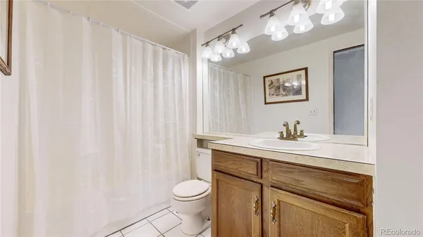 a bathroom with a toilet a sink and a mirror