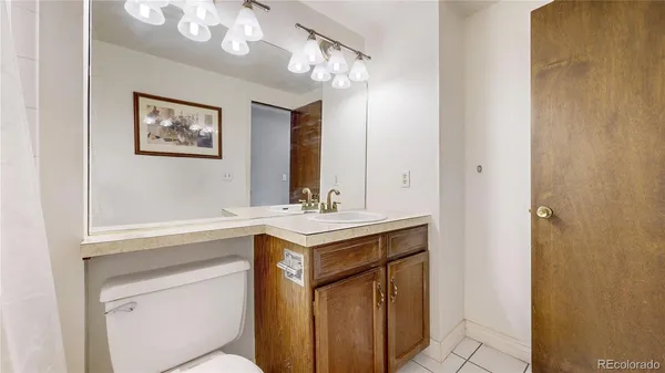 a bathroom with a sink a mirror and a vanity