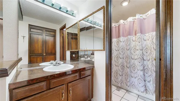 a spacious bathroom with a granite countertop sink and a mirror