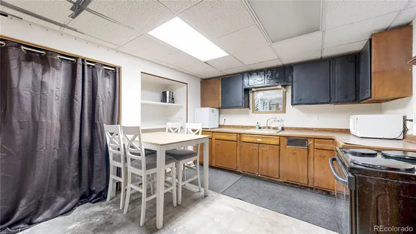 a view of a dining room with furniture window and kitchen view