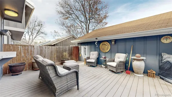 a living room with furniture a fireplace and a chandelier