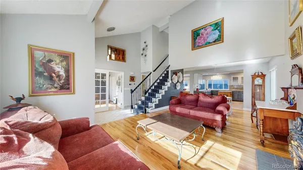 a living room with furniture or stairs and a wooden floor