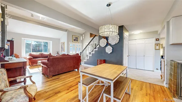 a living room with furniture a rug and white walls